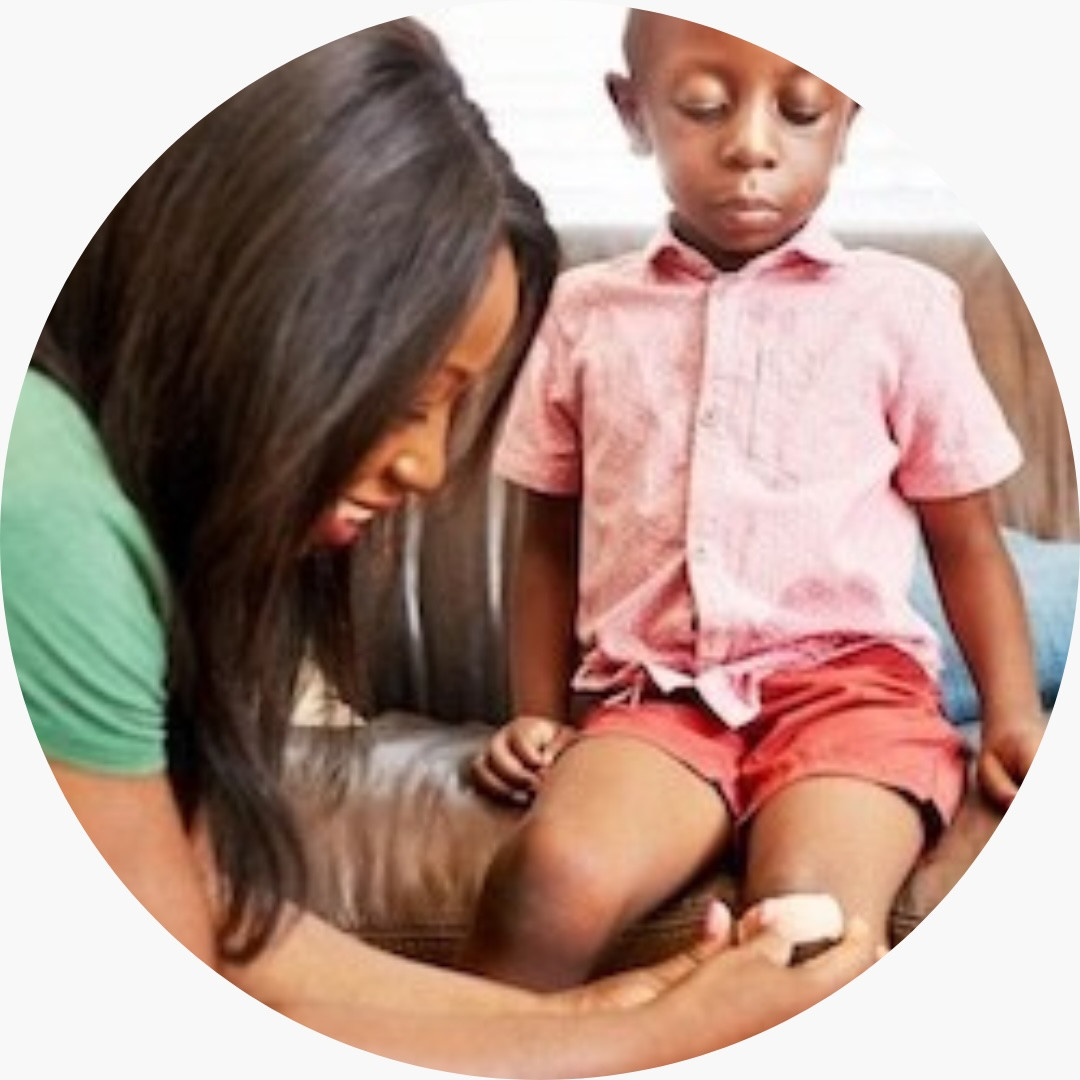 A woman treating a child's scrape