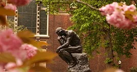 The Thinker near magnolias trees